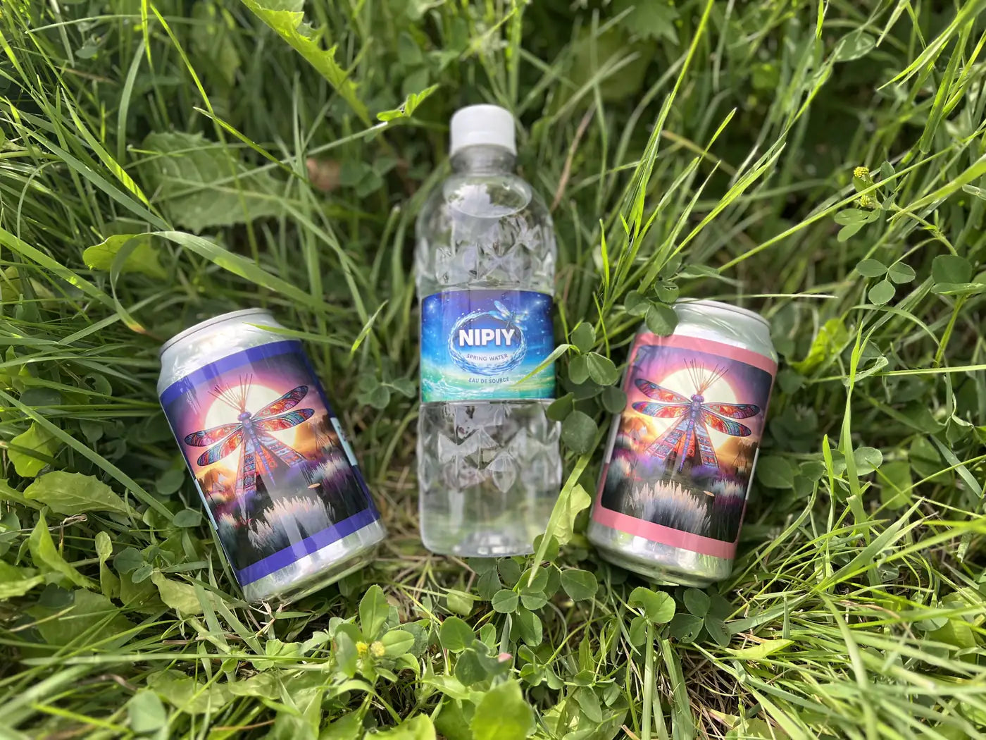 Two Nipiy dragonfly edition cans beside a Spring Nipiy bottle