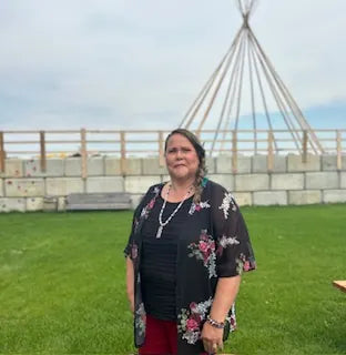 Monique Collins in front of a tipi frame